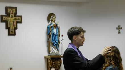 Le prêtre Francisco Marques appose ses mains sur la tête d'une femme lors d'une séance d'exorcisme, le 30 mai 2026 à Fatima, au Portugal