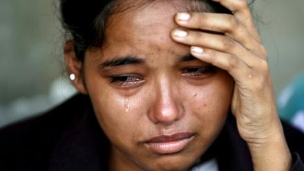 Une femme pleure après avoir été secourue dans un camp militaire à la suite des crues soudaines, dans la ville de Battar Bazar, district de Nuwakot au Népal, le 28 août 2026