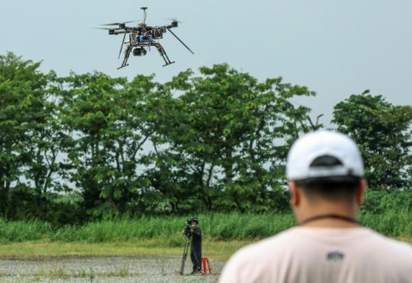 Pilotage d'un drone multirotor lors du deuxième Défi national d'application des drones (UAV) à la défense, le 16 octobre 2024 à Chiayi, à Taïwan