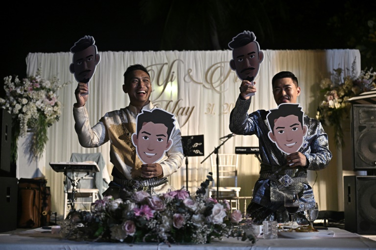 Les Chinois Song Jihan (d) et Wang Zengyi lors de leur mariage près de Pattaya, en Thaïlande, le 31 mai 2025