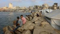 Des Palestiniens se rassemblent sur la plage de Gaza-ville, en bordure de tentes intallées par des déplacés, le 8 juin 2025