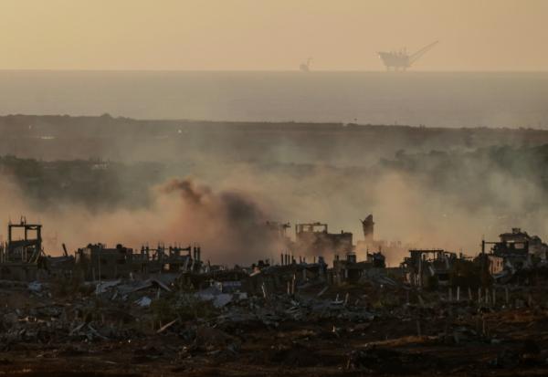 De la fumée est visible au-dessus de bâtiments détruits dans la bande de Gaza lors d'un bombardement israélien, le 21 mai 2025